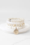 Beaded bracelets set in White Cream with a coin charm