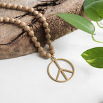 Long Wood Bead Necklace with golden peace sign pendant - Natural Beige