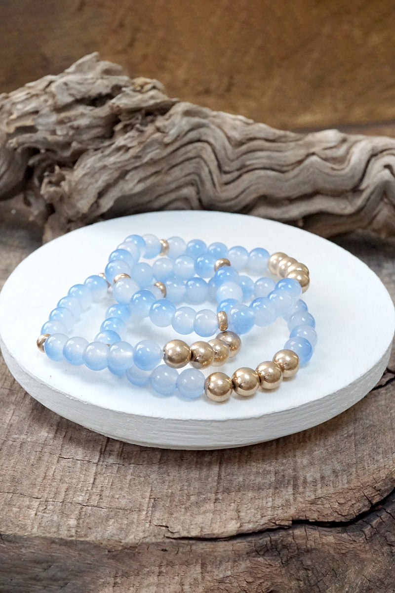 Worn gold tone and glass beads bracelets stack Hot Pink Blue Green
