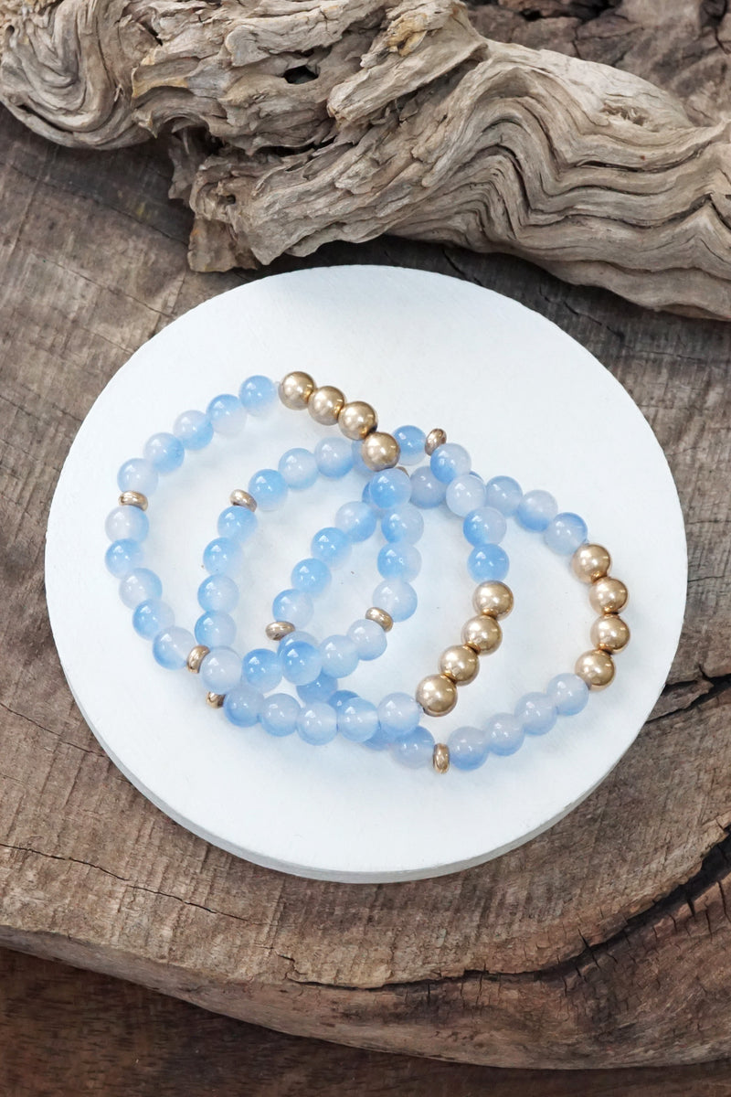 Worn gold tone and glass beads bracelets stack Hot Pink Blue Green