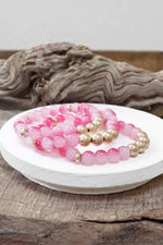 Worn gold tone and glass beads bracelets stack Hot Pink Blue Green