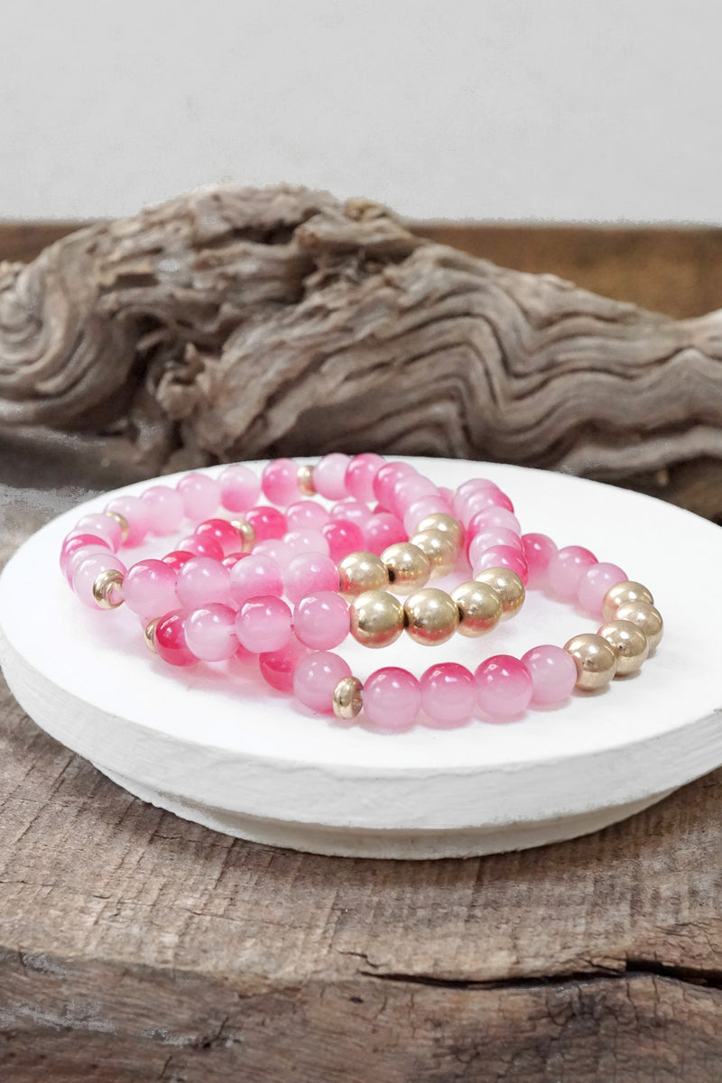 Worn gold tone and glass beads bracelets stack Hot Pink Blue Green