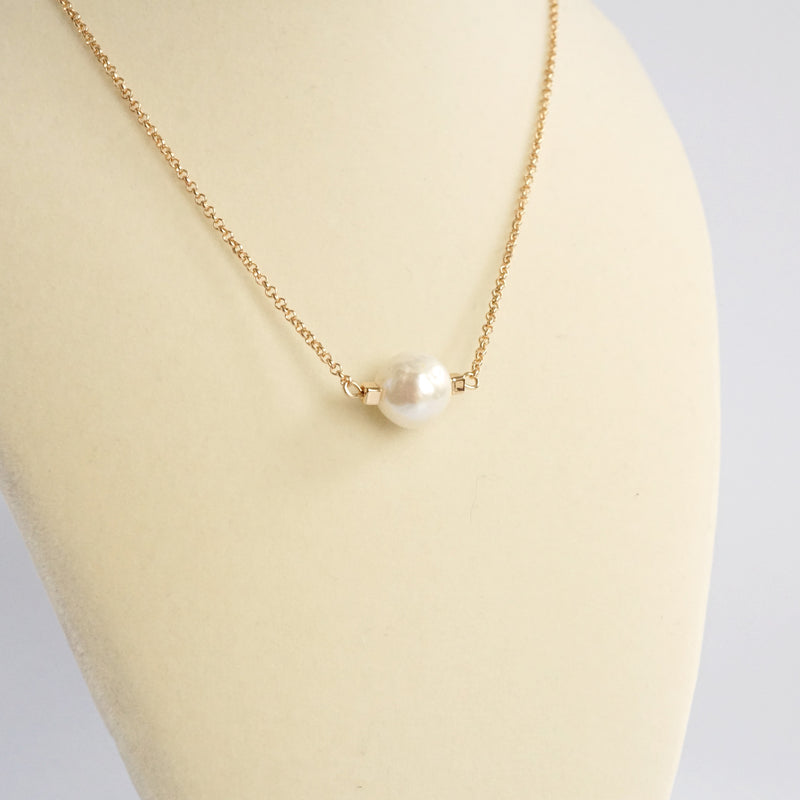 Short dainty necklace with a Pearl in gold tone