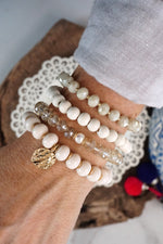 Beaded Bracelets set in White with a coin charm