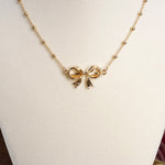 Fancy Bow Necklace - Short dainty station chain in gold tone