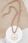 Long Wood Bead Necklace with golden peace sign pendant - Pink