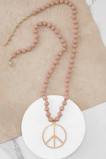 Long Wood Bead Necklace with golden peace sign pendant - Pink