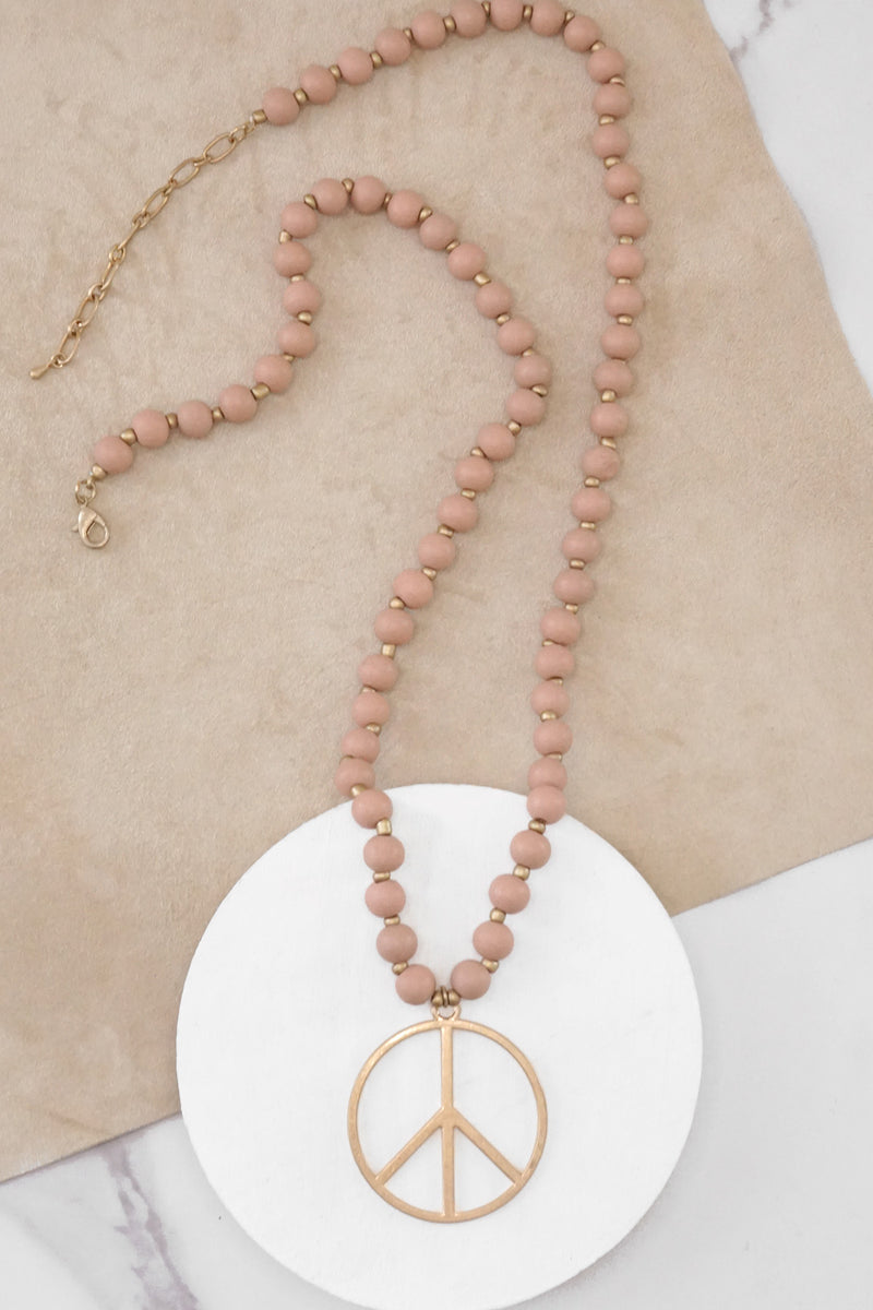 Long Wood Bead Necklace with golden peace sign pendant - Pink