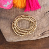 Worn Gold tone multi size beaded bracelet stack of 6 bracelets