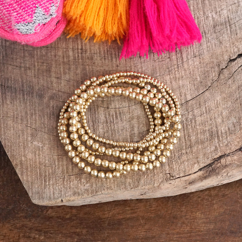 Worn Gold tone multi size beaded bracelet stack of 6 bracelets