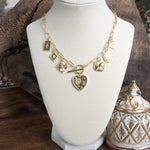 Multi-Charm Statement Necklace with Front Toggle & Heart Crystals – Gold Tone