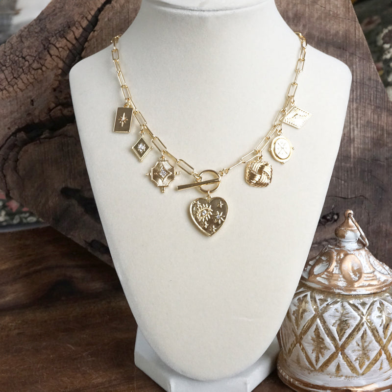 Multi-Charm Statement Necklace with Front Toggle & Heart Crystals – Gold Tone