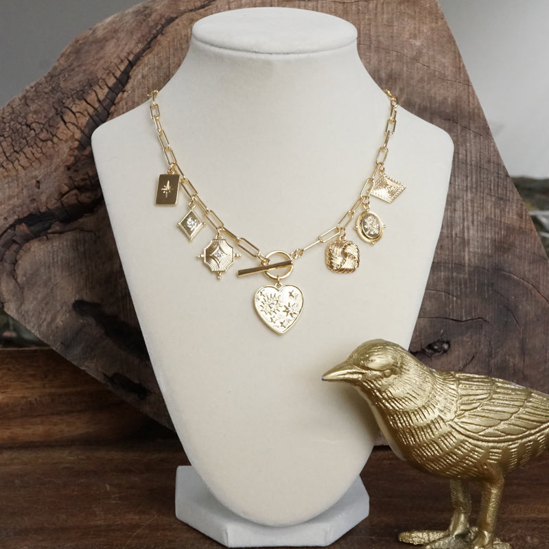 Multi-Charm Statement Necklace with Front Toggle & Heart Crystals – Gold Tone