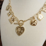 Multi-Charm Statement Necklace with Front Toggle & Heart Crystals – Gold Tone