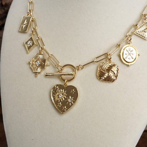 Multi-Charm Statement Necklace with Front Toggle & Heart Crystals – Gold Tone