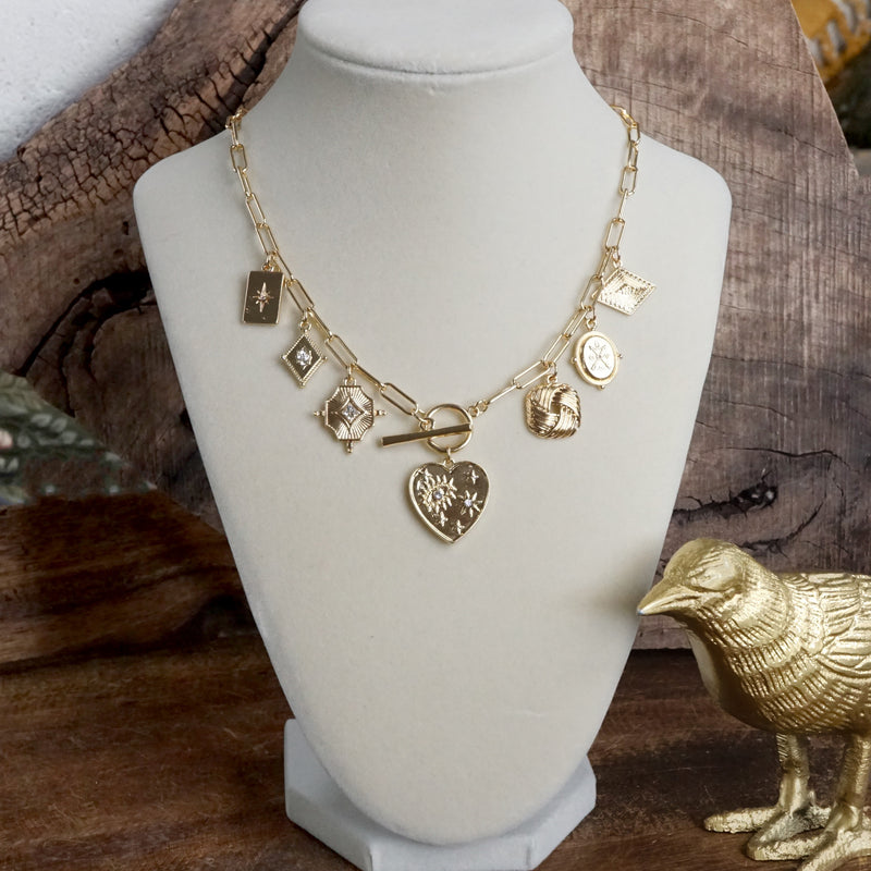 Multi-Charm Statement Necklace with Front Toggle & Heart Crystals – Gold Tone