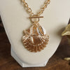 Front Toggle Multi-Charm Shell Statement Necklace – Gold Tone