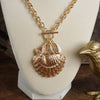 Front Toggle Multi-Charm Shell Statement Necklace – Gold Tone