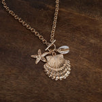 Front Toggle Multi-Charm Shell Statement Necklace – Gold Tone