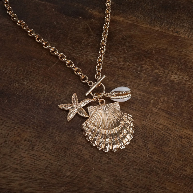 Front Toggle Multi-Charm Shell Statement Necklace – Gold Tone