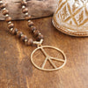 Long Wood Bead Necklace with golden peace sign pendant - Brown