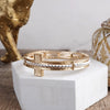 Golden Balance – Minimalist Sideways Cross Stretch Bangle